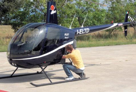 Val di Ledro – pilot checks the Robinson R22 helicopter before take off