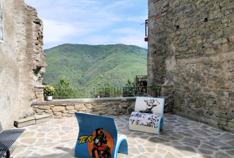 Montereggio – a square in the hamlet with two chairs book shaped