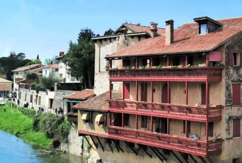 Bassano del Grappa – an ancient building with wooden balconies on the bank of Brenta river – BBofItaly